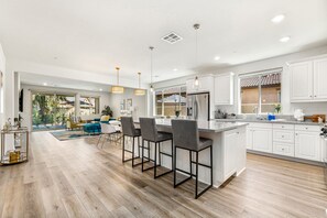 Enjoy cooking in this well-equipped kitchen with a central island and stainless steel appliances.
