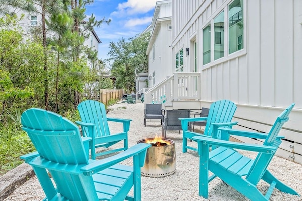 A patio area with outdoor seating and a fire pit.