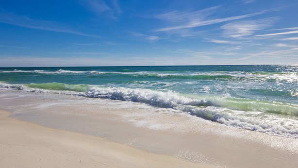 A beach with waves approaching the shore under a clear sky. - 2BR/2BA-Sleeps 6
Seascape Condo at Miramar Beach (Destin)