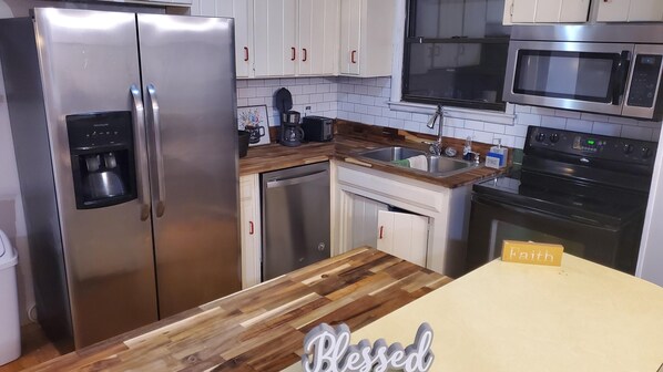 Enjoy cooking in this fully equipped kitchen with a refrigerator, microwave, oven, coffee maker, and toaster.