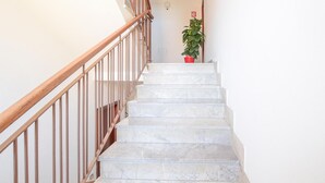 A staircase with marble steps and wooden railings leading to a landing. - Pet friendly apartment in Follonica with WiFi (Follonica)