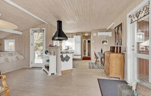 Cozy cabin-style accommodation with a large open-plan living area, kitchen, and dining space.