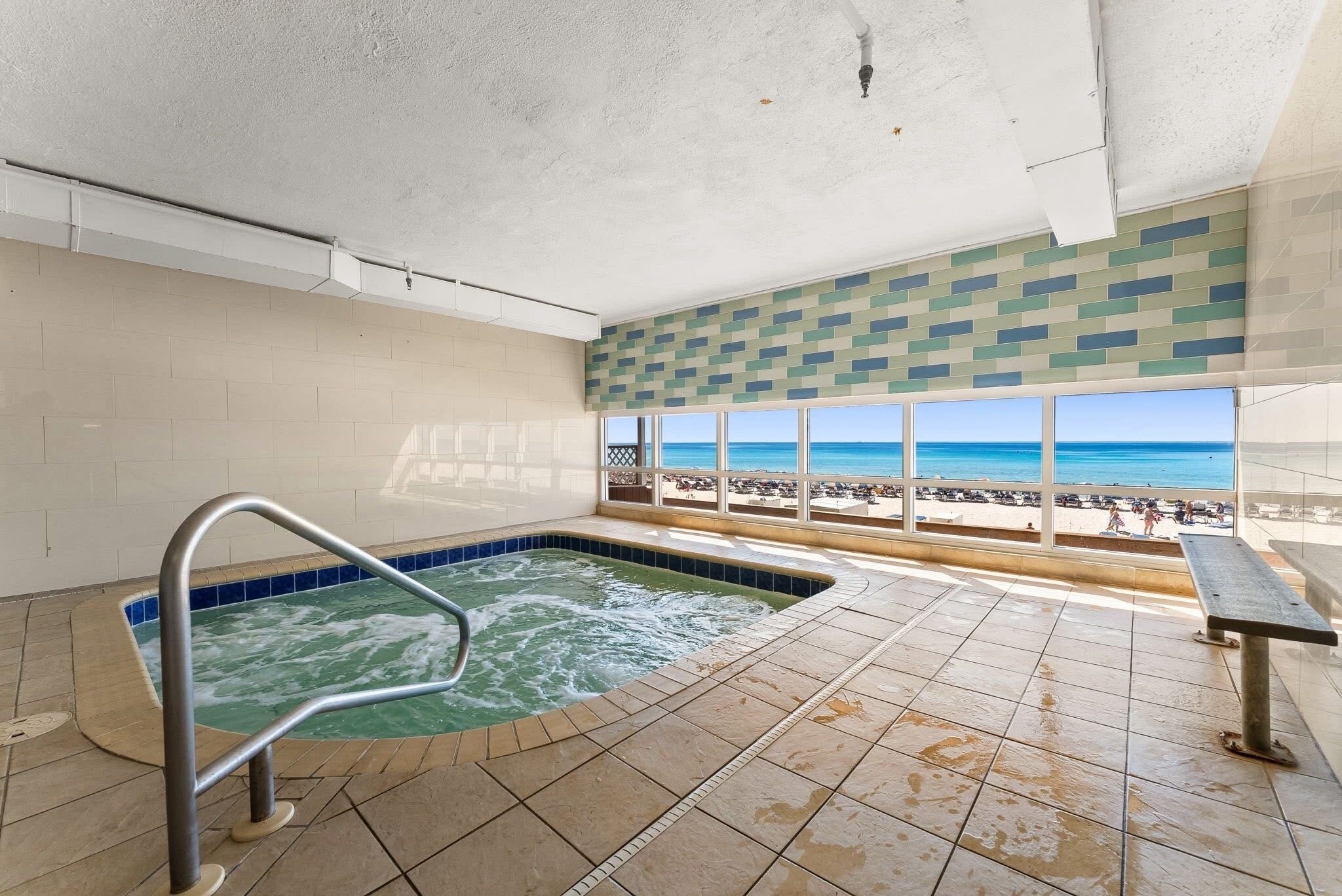 A hot tub area with a view of the beach.