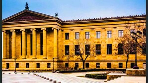 A large, yellow building with columns and a symmetrical facade. - Cozy 1BD Apt @Magic Garden in Center City (Philadelphia)