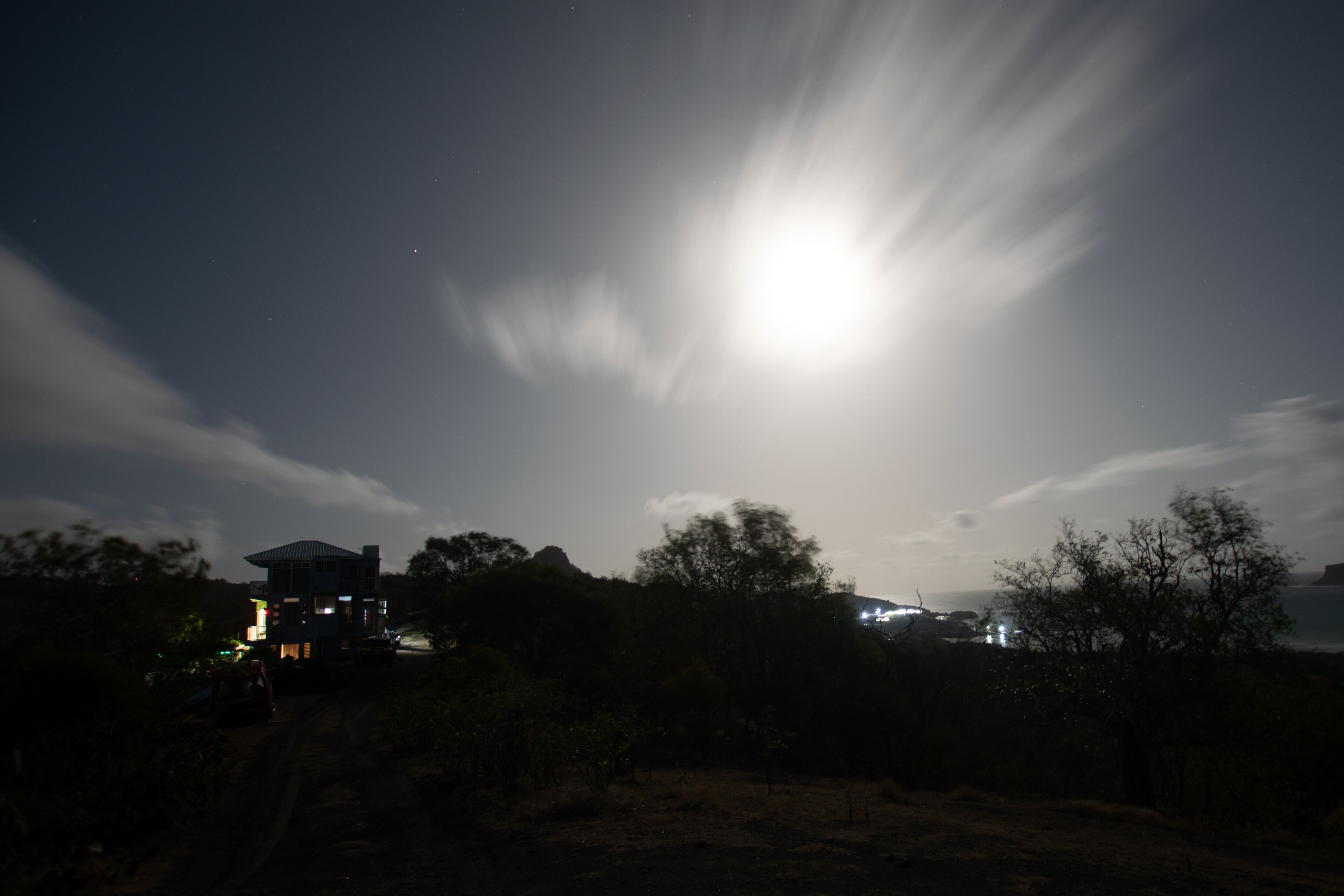 A house with a visible balcony and a clear view of the sky.