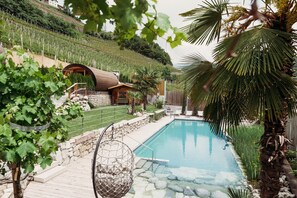 Una piscina al aire libre de temporada, sombrillas
