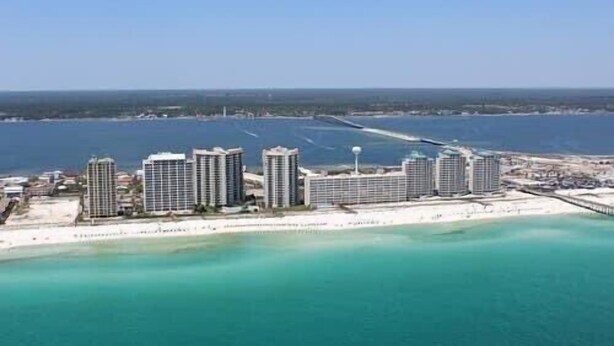 A coastal hotel with multiple high-rise buildings, a beach in the foreground, and a clear view of the ocean. - Quiet Family Friendly Saltwater Pool Home, Near Beach (Navarre)
