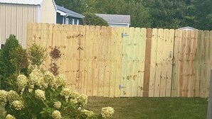 A wooden fence with a gate in a backyard. - Romantic king suite located 15 minutes from U of I (Saint Joseph)