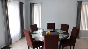 A dining area with a round table, six chairs, and a chandelier. - Detached 3 BR home in Ajax,ON (Ajax)