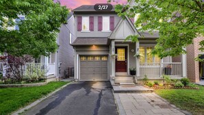 A two-story house with a garage, a front porch, and a well-maintained garden. - Detached 3 BR home in Ajax,ON (Ajax)