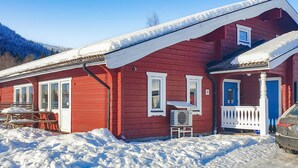 A red wooden house with a snow-covered roof, a porch, and a number 51 sign. - Cozy home in Sysslebäck with kitchen (Sysslebäck)