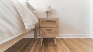 A bedroom with a bed, a nightstand with a lamp, and a framed artwork on the wall. - Sunny & Stylish Manayunk Cottage w/ Private Back Yard (Philadelphia)