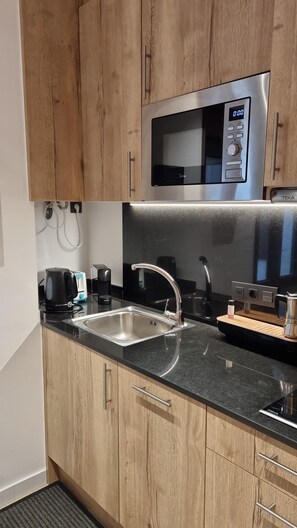 A modern kitchen with wooden cabinets, a stainless steel sink, a microwave, and a coffee maker. - 603 SKY - Apt 1 hab- 4 oers 10 m pistes Pas de la Casa-007994 (Pas de la Casa)