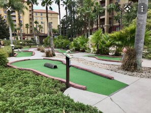 Play a round of golf amidst lush greenery and scenic obstacles.