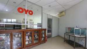 A room with a wooden cabinet displaying various items, a glass display case, and a metal table with a fish tank.