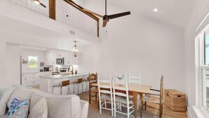 A spacious living area with a dining table, chairs, and a sofa. - Spacious 3BR Beach Retreat Sleeps 10 | Family Ready (Port St. Joe)