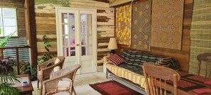 Relax in a traditional room with a sofa, dining area, and wall art featuring geometric patterns.