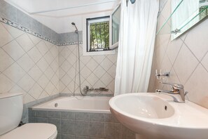 A bathroom with a bathtub, a toilet, and a sink. - Villa Katina - private pool & sea view (Corfu)