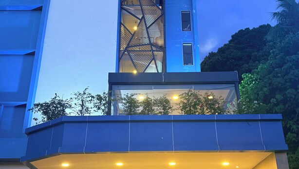 A hotel entrance with a modern design, a visible reception desk, and a staircase leading to the upper floors. - Golden Paradise Hotel (Karon)