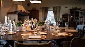 A dining table set with wine glasses, water bottles, and a centerpiece of flowers. - Podere Val D'Orcia - Tuscany Equestrian (Sarteano)