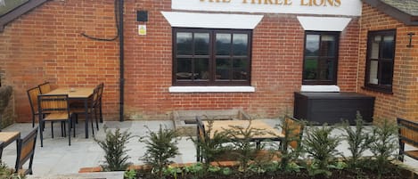 A brick building with a sign reading "The Three Lions."