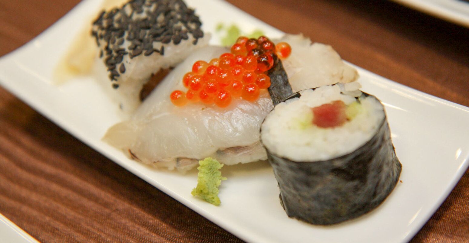 A plate of sushi with various toppings.