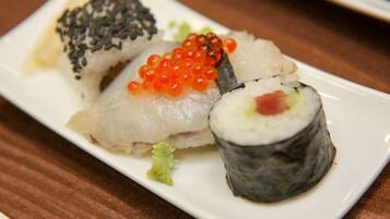 A plate of sushi with various toppings.