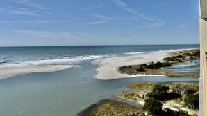 A coastal landscape with a sandy beach, calm waters, and a clear sky. - Oceanfront! - All New! Ultra Modern Farmhouse Chic at the Beach! (Myrtle Beach)