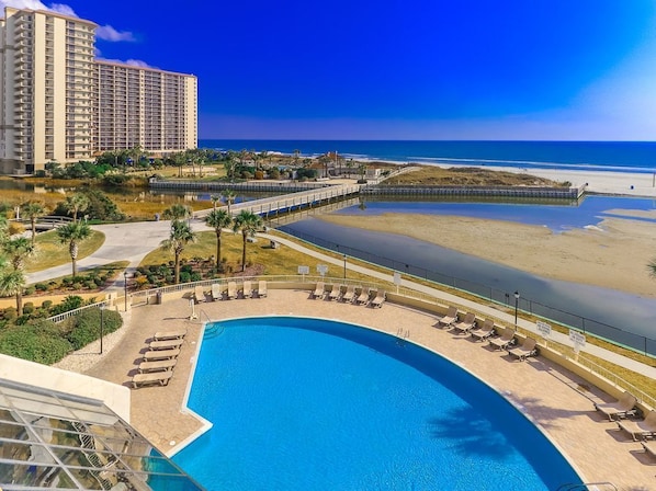 Relax by the oceanfront pool surrounded by lounge chairs and a scenic walking path.