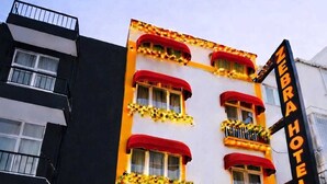 A hotel with a red awning, multiple windows, and a sign reading "Zebra Hotel". - Zebra Hotel Alsancak (Izmir)