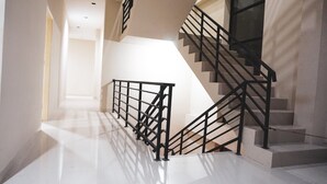 A modern staircase with black railings and a polished floor.