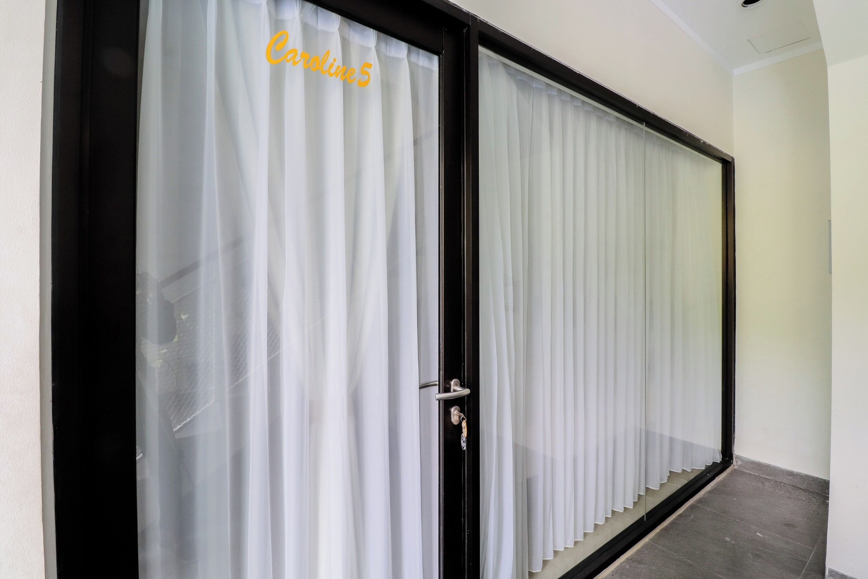 A sliding door with a frosted glass panel and a door handle.