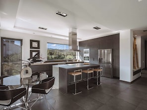 A modern kitchen with a large island, stainless steel appliances, and a view of the outdoors. - Villa Vega Heated* pool, next to nature! (Chania)