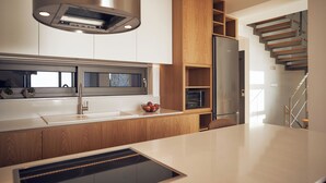 A modern kitchen with wooden cabinets, a stainless steel range hood, and a built-in oven. - Omnia Villa II - Heated* pool & dazzling seaview! (Chania)
