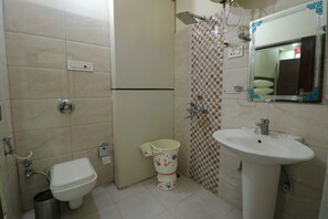 A bathroom with a toilet, a sink, and a shower. - Hotel Eurasia Mohali Airport (Mohali)