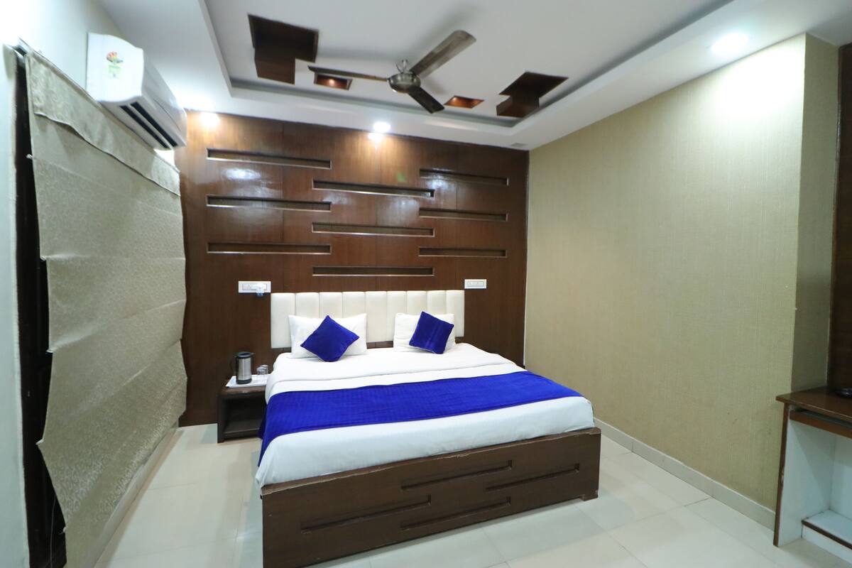 A bedroom with a bed, nightstand, and a ceiling fan.