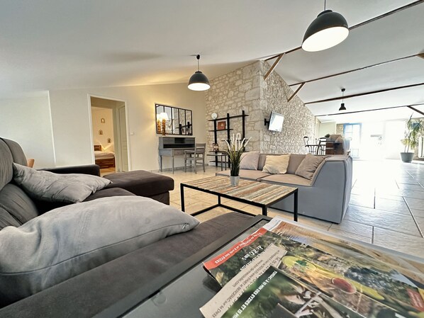 A modern living room with a sofa, coffee table, and a stone accent wall.