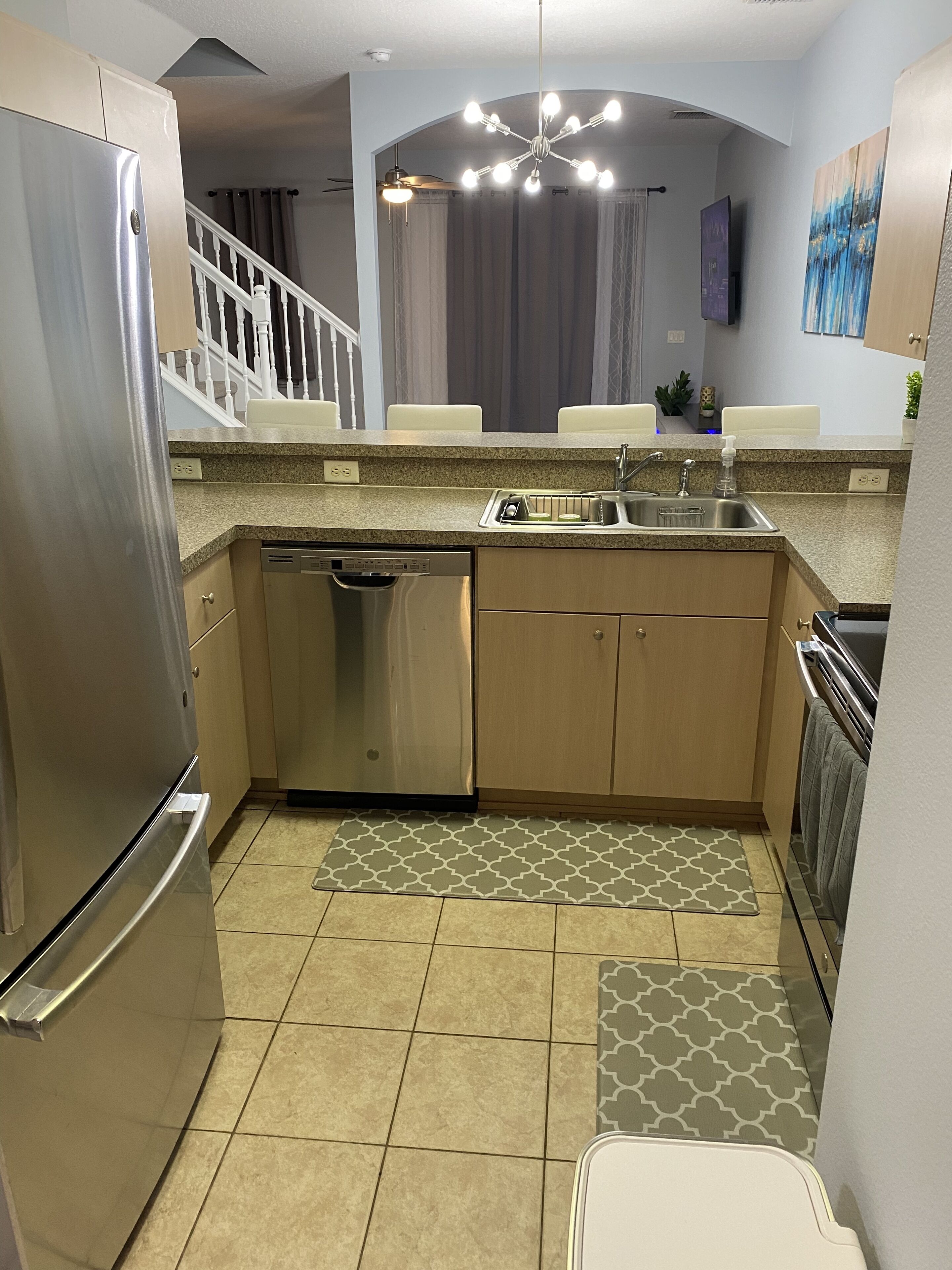 A modern kitchen with stainless steel appliances, a dishwasher, and a sink.