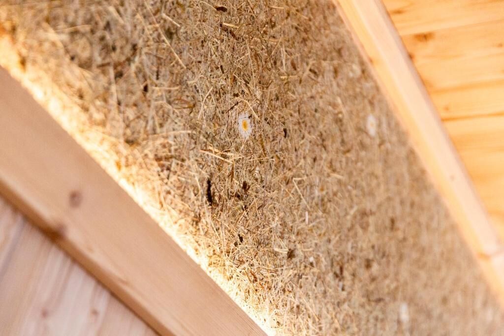 A close-up of a wooden structure with a textured surface, possibly a part of a building's interior or exterior.