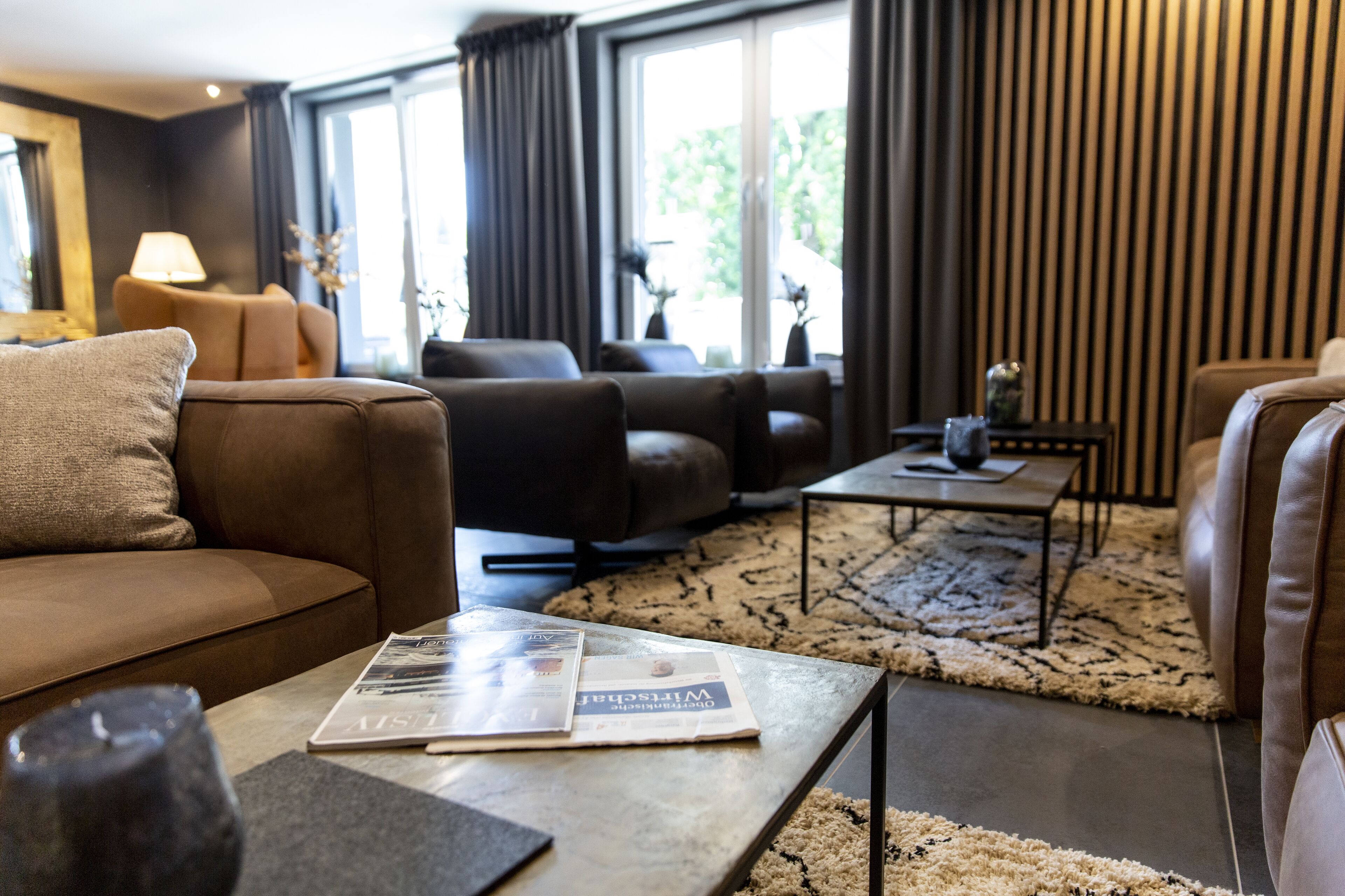 A modern living room with a sofa, armchair, and coffee table.