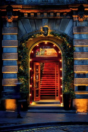 A hotel entrance with a red door, decorative arches, and a sign that reads 'Virgin Hotels.' - Virgin Hotels Edinburgh (Edinburgh)