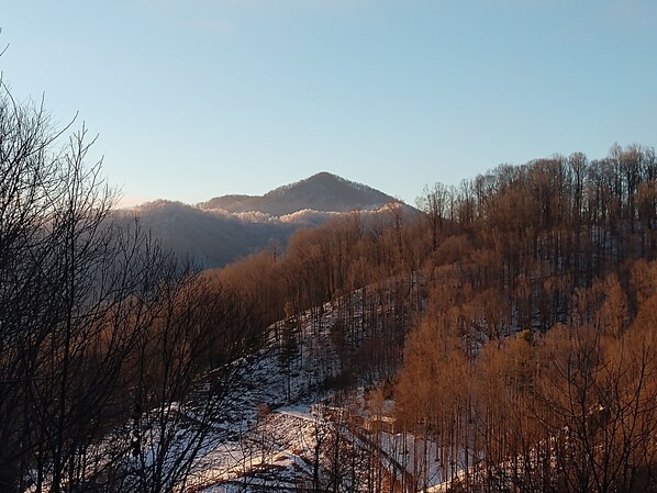 A mountainous landscape with a clear sky, featuring a valley with sparse trees and a distant hill. - Remote & Private Cabin with Spa, Mountain Views and Hiking to Appalachian Trail. (Burnsville)