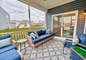 A covered patio with a sofa, chairs, and a small table. - Ocean View * 5BR Luxury Single Family House! (Ocean View)