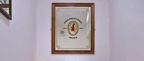 A bathroom with a toilet, sink, and a framed certificate on the wall.
