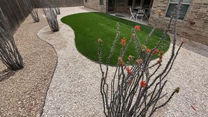 A backyard with a green lawn, a wooden fence, and a brick house. - Enormous house with new backyard (Midland)