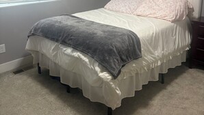 A bedroom with a bed, a window with blinds, a nightstand, and a carpeted floor. - Spacious five bedroom , 3 bathroom home . 1 mile from downtown Sturgis. (Sturgis)