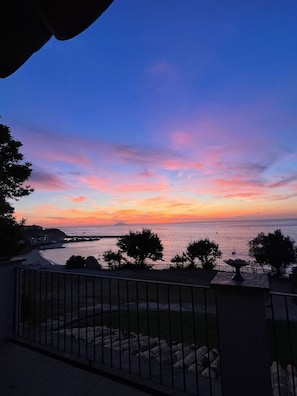 Enjoy breathtaking ocean views from your balcony, where the sky transitions to a serene blue above the calm sea.