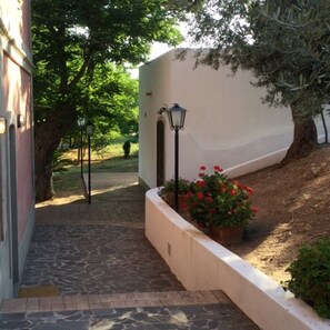 Stroll through the serene garden, surrounded by vibrant flowers and a lush lawn.