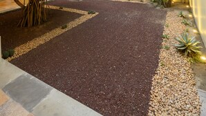 A landscaped outdoor area with a gravel path, various plants, and a building entrance. - XTILU Hotel - Adults only (Oaxaca)
