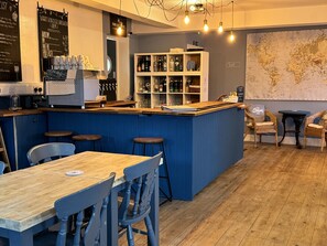 A bar area with stools, a counter, and a world map on the wall. - The Pilot Boat Inn (Bembridge)